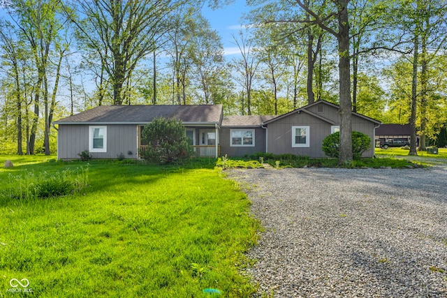 single story home featuring driveway and a front lawn