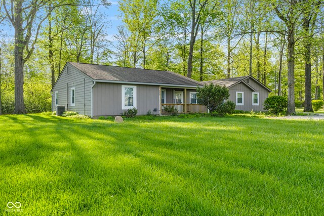 ranch-style home with central AC, a front yard, and a shingled roof