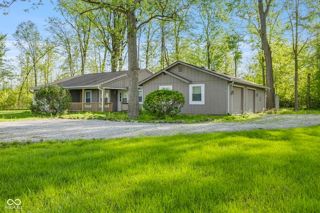 single story home featuring covered porch and gravel driveway