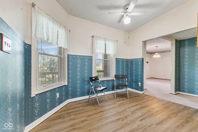 sitting room with wood finished floors, plenty of natural light, ceiling fan, baseboards, and wallpapered walls