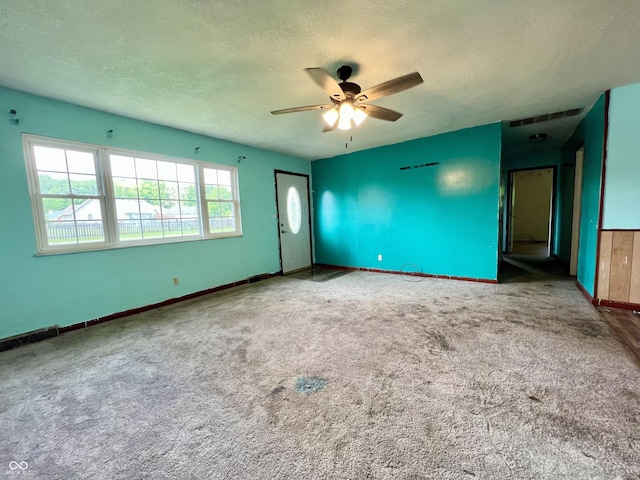 206 Windemere Rd, West Terre Haute, IN 47885 - unfurnished living room featuring a textured ceiling, ceiling fan, carpet, and baseboards