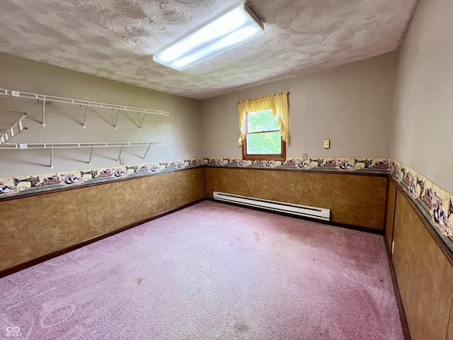 206 Windemere Rd, West Terre Haute, IN 47885 - spare room with baseboard heating, carpet flooring, a textured ceiling, and a wainscoted wall