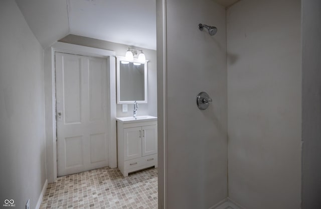 full bath with a shower, vanity, lofted ceiling, a chandelier, and baseboards