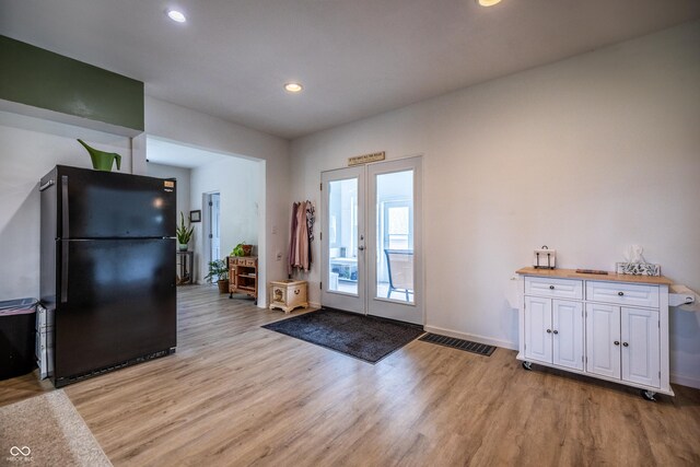 entryway featuring light wood-style floors, french doors, recessed lighting, and baseboards