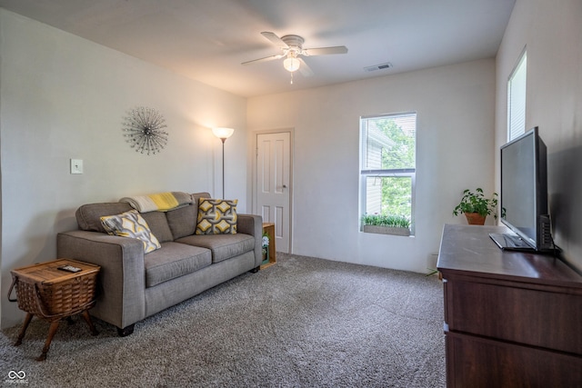 carpeted living room with a ceiling fan
