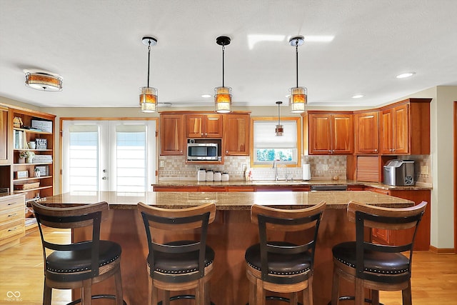 2769 S 800 W, Indianapolis, IN 46239 - kitchen with stainless steel microwave, a sink, healthy amount of natural light, light wood-type flooring, and recessed lighting