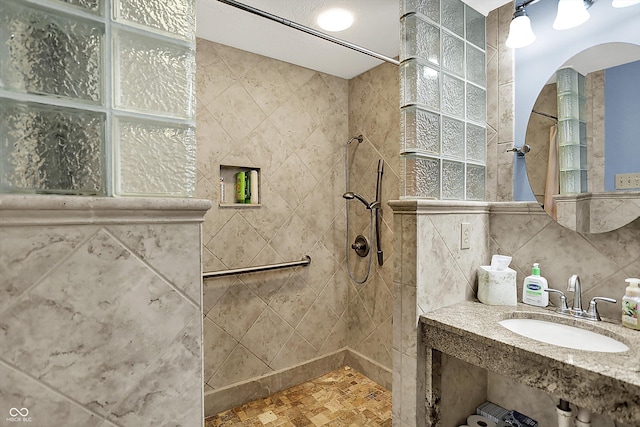 2769 S 800 W, Indianapolis, IN 46239 - bathroom featuring a sink, walk in shower, tile walls, and tasteful backsplash