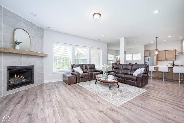 15792 Wiseman Dr, Fishers, IN 46040 - living area featuring light wood-type flooring, healthy amount of natural light, baseboards, recessed lighting, and a fireplace