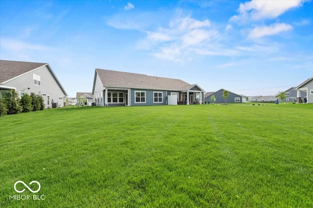 back of house with a yard