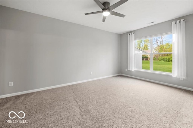 unfurnished room featuring baseboards, carpet, and a ceiling fan