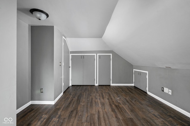 bonus room featuring baseboards, wood finished floors, and lofted ceiling