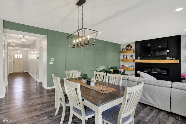 4032 Stubbington Ln, Indianapolis, IN 46239 - dining room featuring a chandelier, dark wood-type flooring, baseboards, a glass covered fireplace, and recessed lighting