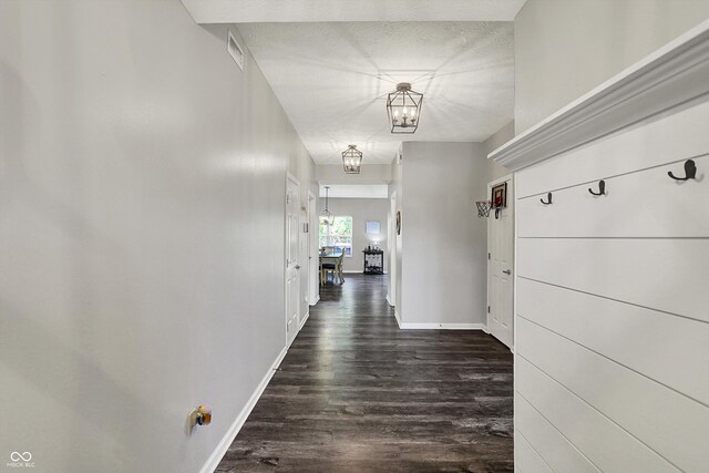 4032 Stubbington Ln, Indianapolis, IN 46239 - hallway with a chandelier, dark wood finished floors, and baseboards