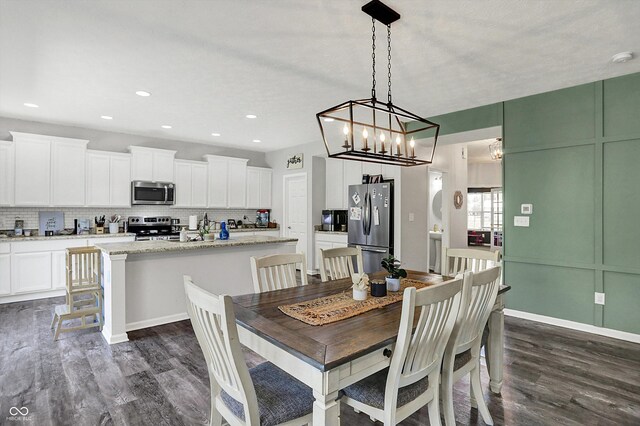 4032 Stubbington Ln, Indianapolis, IN 46239 - dining area with dark wood-style floors, a chandelier, baseboards, and recessed lighting