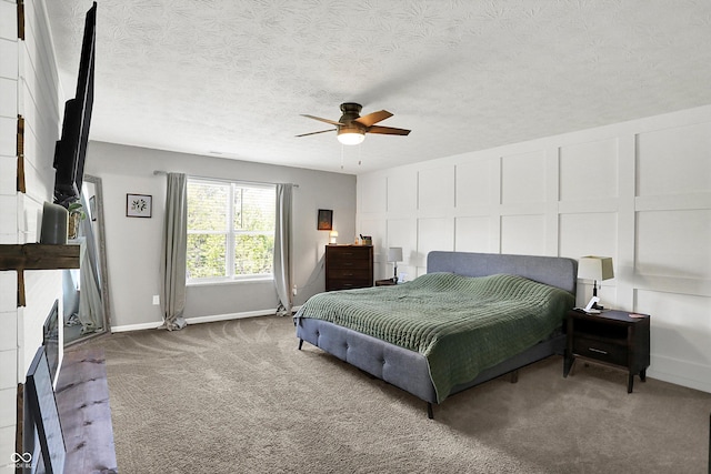 4032 Stubbington Ln, Indianapolis, IN 46239 - bedroom featuring carpet floors, a fireplace, a decorative wall, baseboards, and a ceiling fan
