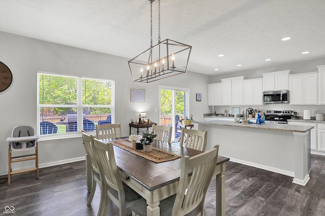 4032 Stubbington Ln, Indianapolis, IN 46239 - dining room featuring dark wood-style flooring, recessed lighting, baseboards, and a chandelier