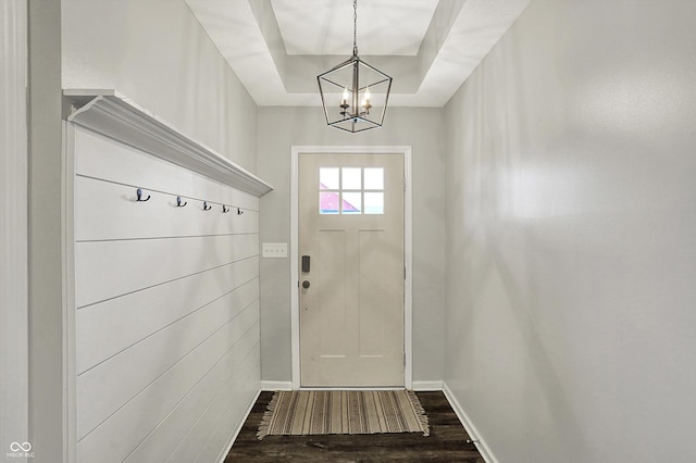 4032 Stubbington Ln, Indianapolis, IN 46239 - doorway to outside with dark wood-style flooring, a chandelier, baseboards, and a raised ceiling