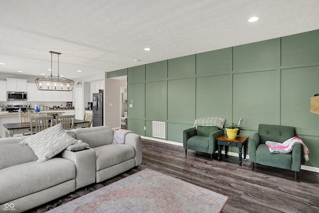 4032 Stubbington Ln, Indianapolis, IN 46239 - living area featuring a chandelier, dark wood finished floors, recessed lighting, and a decorative wall
