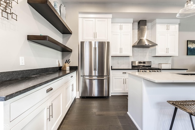 kitchen featuring stainless steel appliances, open shelves, wall chimney range hood, dark wood finished floors, and white cabinets