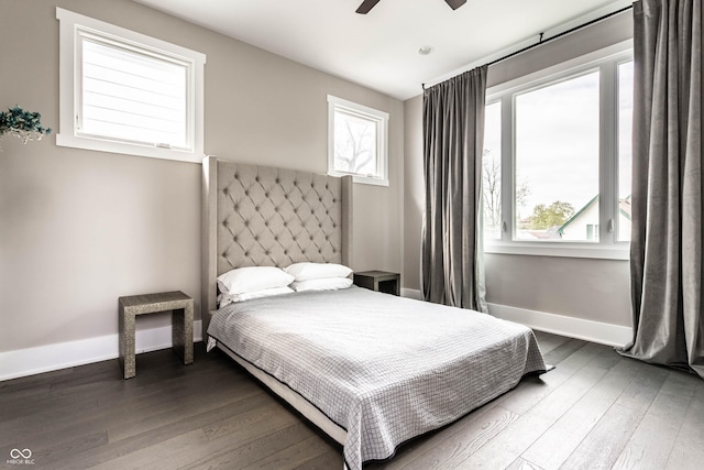 bedroom featuring dark wood-style flooring, baseboards, and a ceiling fan