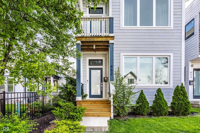 doorway to property featuring fence and a balcony