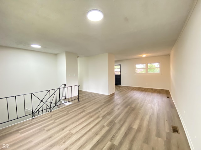 empty room featuring baseboards and wood finished floors