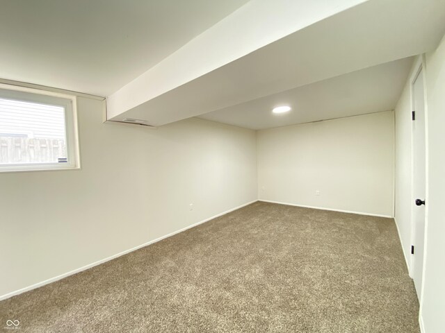 below grade area featuring carpet flooring, baseboards, and recessed lighting