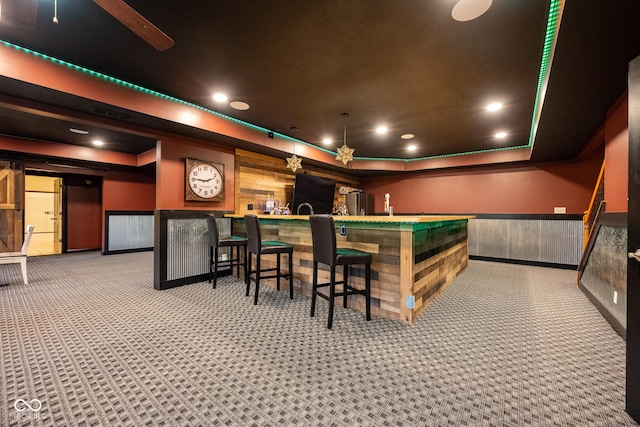 4890 Benthaven Dr E, Bargersville, IN 46106 - cinema with a raised ceiling, carpet, a wainscoted wall, a community bar, and recessed lighting