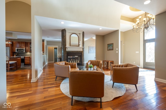 4890 Benthaven Dr E, Bargersville, IN 46106 - living room with wood-type flooring, a high ceiling, baseboards, a multi sided fireplace, and a chandelier