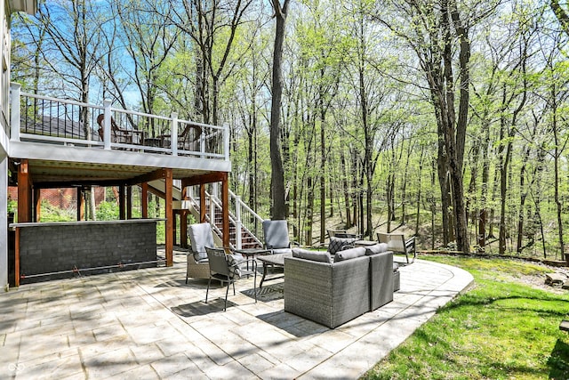 view of patio featuring an outdoor hangout area, a deck, and stairs