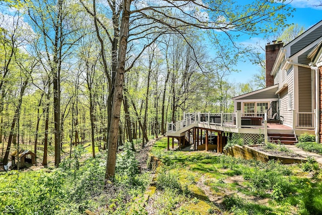 view of yard featuring a wooden deck and stairway