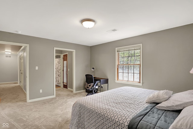 bedroom featuring light colored carpet and baseboards
