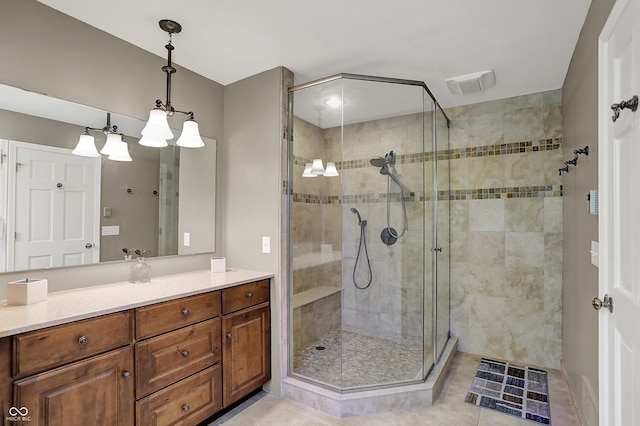 bathroom featuring a shower stall, vanity, and tile patterned floors