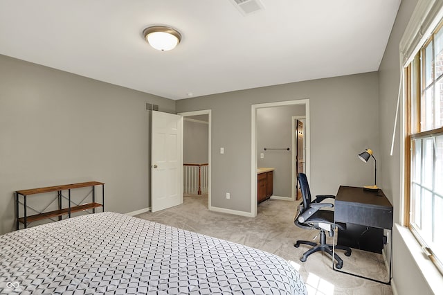 bedroom featuring light colored carpet, a desk, and baseboards