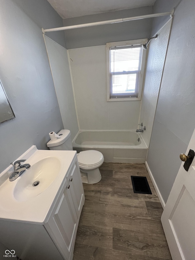 2037 Glenridge Dr, Indianapolis, IN 46218 - full bathroom with shower / washtub combination, toilet, wood finished floors, and vanity