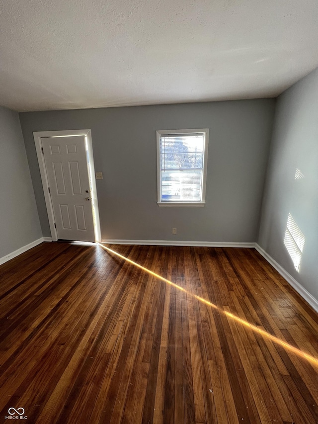 2037 Glenridge Dr, Indianapolis, IN 46218 - empty room with dark wood-type flooring and baseboards