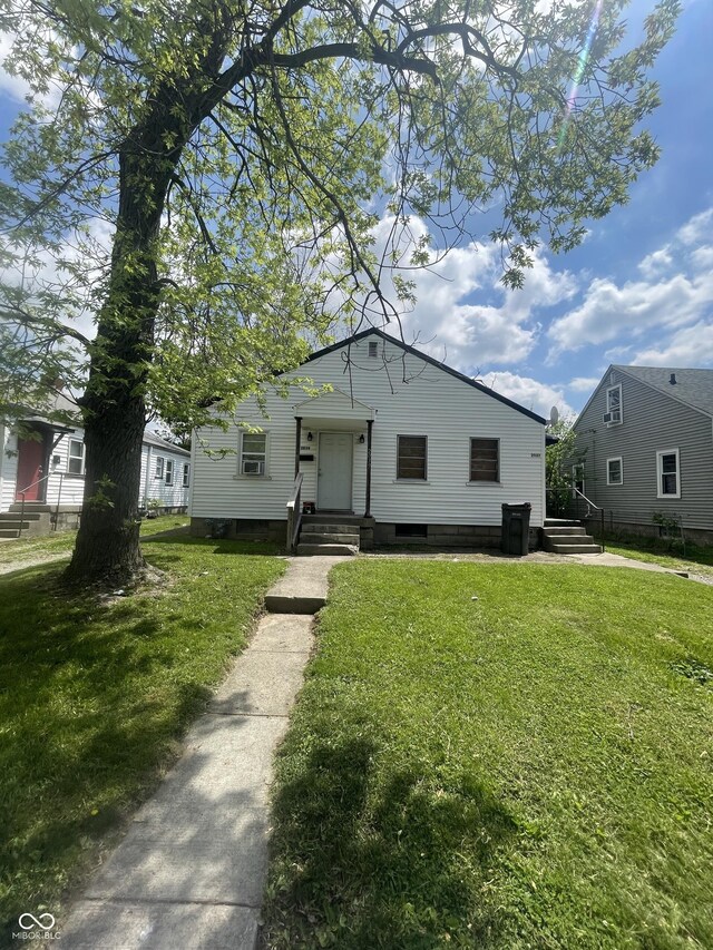 2037 Glenridge Dr, Indianapolis, IN 46218 - bungalow-style house with a front yard