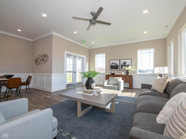 living area with wood finished floors, ceiling fan, recessed lighting, a wainscoted wall, and french doors