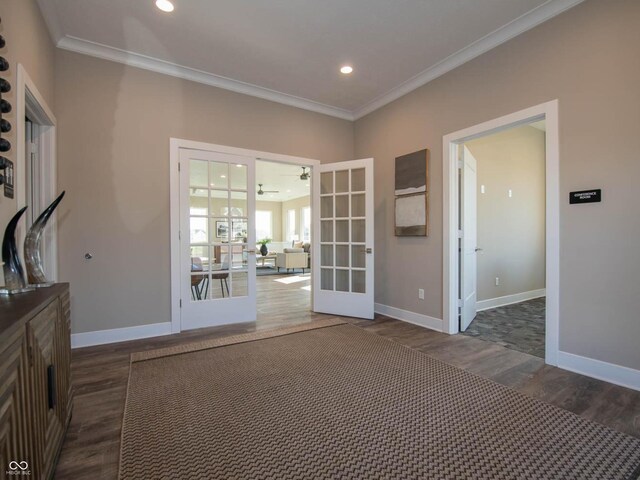empty room with french doors, wood finished floors, ornamental molding, baseboards, and recessed lighting