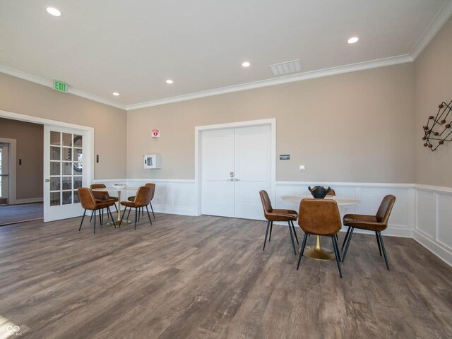 dining room featuring french doors, crown molding, a wainscoted wall, wood finished floors, and recessed lighting