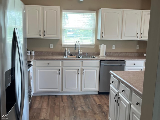 14058 Southwood Cir, Fishers, IN 46037 - kitchen featuring appliances with stainless steel finishes, a sink, white cabinetry, dark wood-style flooring, and light countertops