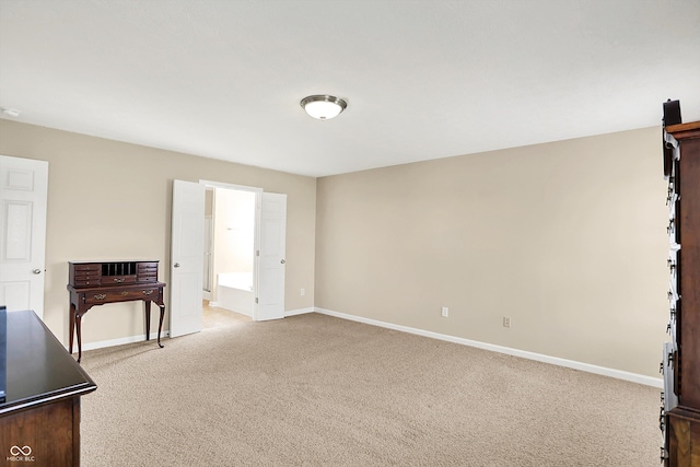 spare room with light colored carpet and baseboards