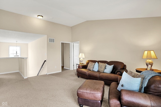 living room featuring carpet floors, baseboards, and lofted ceiling
