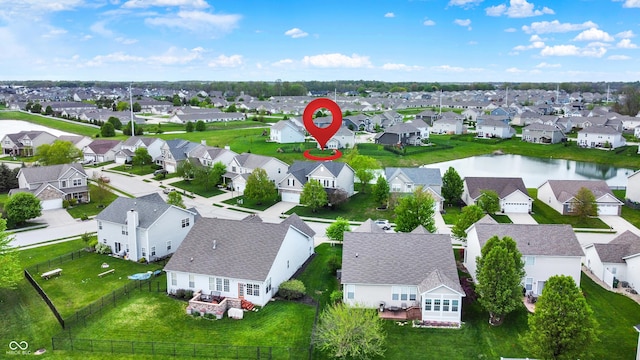 aerial view of residential area featuring a nearby body of water