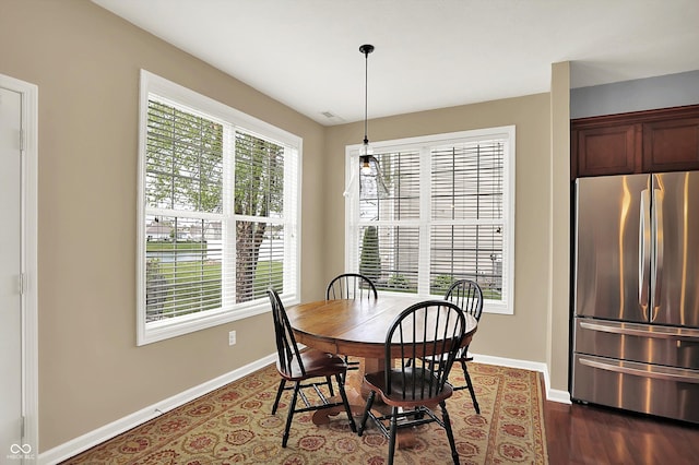 dining room with baseboards and dark wood finished floors