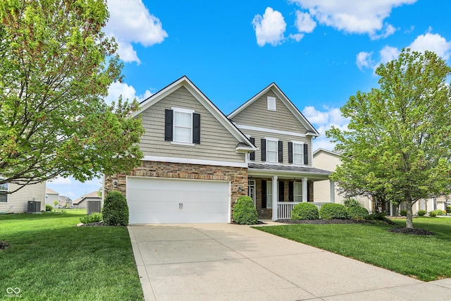 traditional-style home with covered porch, an attached garage, stone siding, concrete driveway, and a front yard