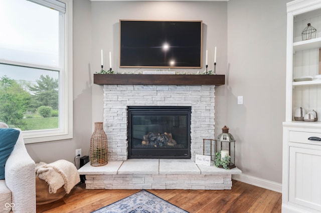 16270 Northwind Ct, Westfield, IN 46074 - living area featuring wood finished floors, a fireplace, baseboards, and built in shelves