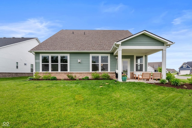 16270 Northwind Ct, Westfield, IN 46074 - rear view of property featuring a yard, brick siding, a shingled roof, and an outdoor hangout area