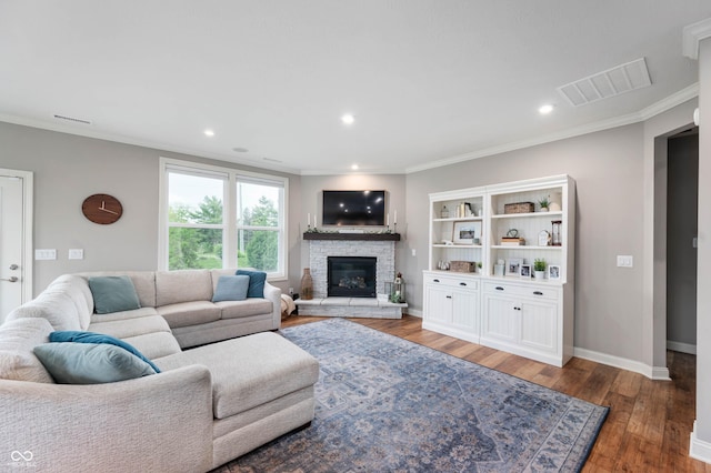 16270 Northwind Ct, Westfield, IN 46074 - living area with a stone fireplace, wood finished floors, crown molding, baseboards, and recessed lighting