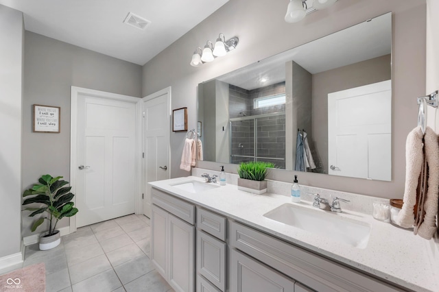 16270 Northwind Ct, Westfield, IN 46074 - full bathroom with a shower stall, double vanity, tile patterned floors, and baseboards